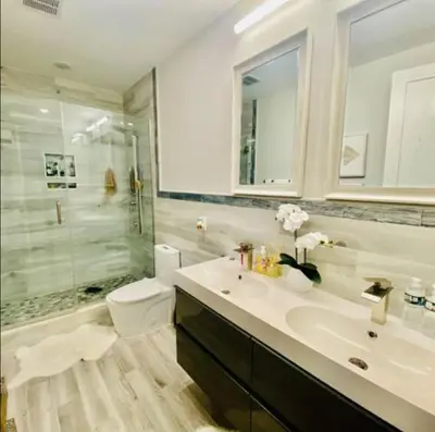 a bathroom with a sink and a shower and a toilet at Contemporary Luxury 3 Bdr Apt for 6 with Free Parking in Jersey City
