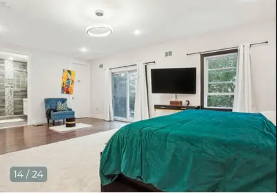 a bedroom with a bed and a flat screen tv at Contemporary Luxury 3 Bdr Apt for 6 with Free Parking in Jersey City