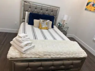 a bedroom with a large bed with towels on it at Contemporary Luxury 3 Bdr Apt for 6 with Free Parking in Jersey City