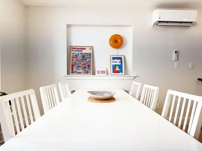 a white dining room with a table and chairs at The Executive - Center-City - 3BR-4Bath-Private-Garage in Philadelphia