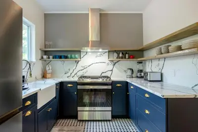 a kitchen with blue cabinets and a stove top oven at Cozy Cottage on a Private Farm Nestled Among the Southern Catskill Mountains in Woodridge, New York in Woodridge
