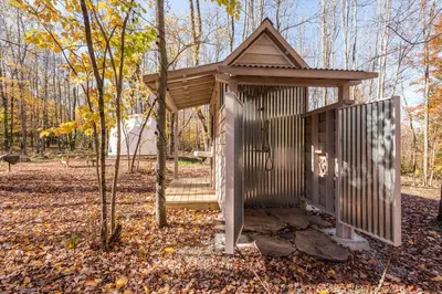 a small wooden out house in the woods at Cozy Unique Dome for a Romantic Glamping Getaway on a Private Farm in Woodridge, New York in Woodridge