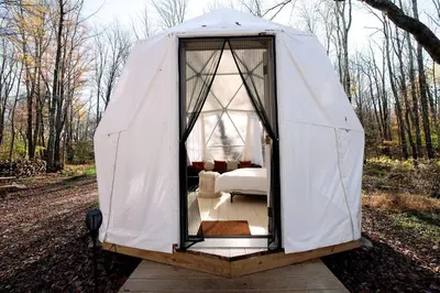 a bedroom in a tent in the woods at Cozy Unique Dome for a Romantic Glamping Getaway on a Private Farm in Woodridge, New York in Woodridge