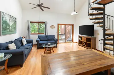 a living room with a blue couch and a tv at Cozy Loft Near Lake Trails and Mountain Views in Vernon Township