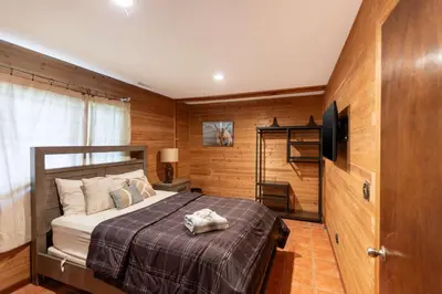 a bedroom with a bed and a television in it at Cozy Loft Near Lake Trails and Mountain Views in Vernon Township