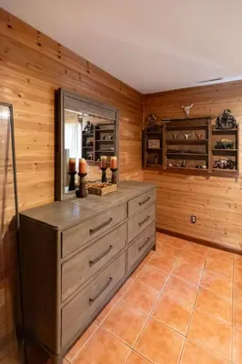 a kitchen with wooden walls and a dresser in a room at Cozy Loft Near Lake Trails and Mountain Views in Vernon Township