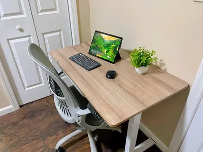 a desk with a laptop computer on top of it at Cozy 2BR Brick Haven! Near light rail! 35m to NYC in Jersey City