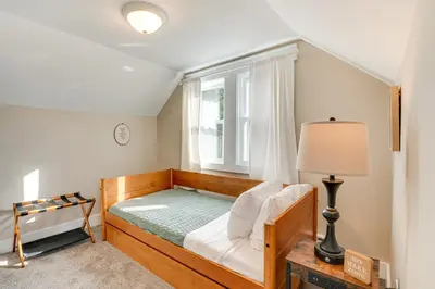 a bedroom with a wooden bed with a window at Recently Renovated Harveys Lake Retreat with Dock! in Harveys Lake