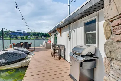 a grill on a dock next to a boat at Recently Renovated Harveys Lake Retreat with Dock! in Harveys Lake