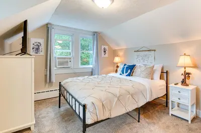 a bedroom with a large bed and a window at Recently Renovated Harveys Lake Retreat with Dock! in Harveys Lake