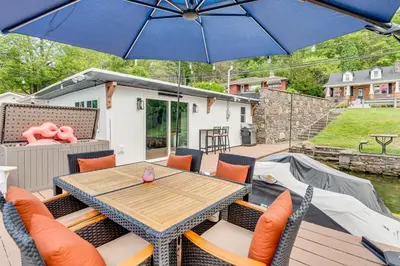 a patio with a table and chairs and an umbrella at Recently Renovated Harveys Lake Retreat with Dock! in Harveys Lake