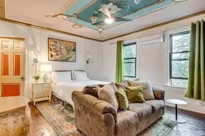 a bedroom with a couch and a bed at Near Downtown Scranton Getaway with Patio in Scranton