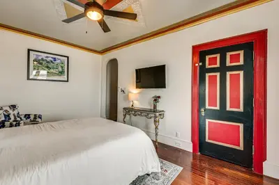a bedroom with a bed and a red door at Near Downtown Scranton Getaway with Patio in Scranton