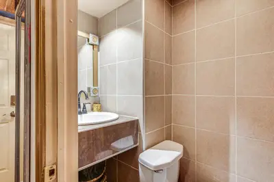 a bathroom with a toilet and a sink at Near Downtown Scranton Getaway with Patio in Scranton