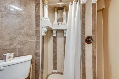 a bathroom with a toilet and a shower curtain at Near Downtown Scranton Getaway with Patio in Scranton