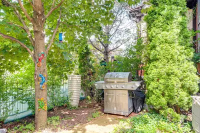 a grill in a yard next to a tree at Near Downtown Scranton Getaway with Patio in Scranton