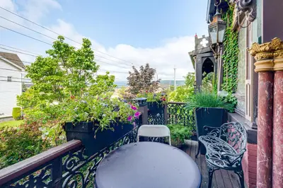 a balcony with a table and chairs and plants at Near Downtown Scranton Getaway with Patio in Scranton