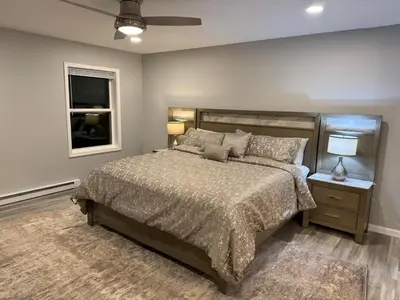 a bedroom with a large bed and a window at Escape to Luxury in the Poconos Your Year-Round Family Retreat in Daleville