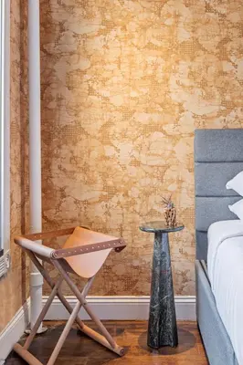 a bedroom with a chair and a bed and a table at Studio Nolita in New York