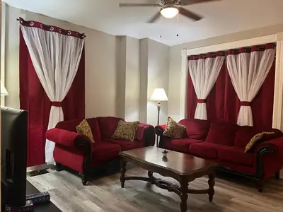 a living room with a red couch and a coffee table at Little France Alsace in Phillipsburg
