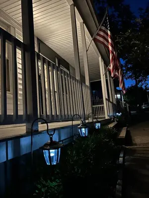 a group of lights in front of a building with a flag at Little France Alsace in Phillipsburg