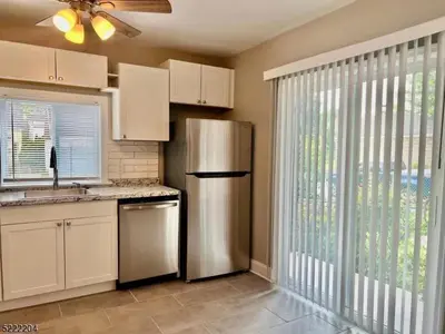 a kitchen with a stainless steel refrigerator next to a window at Little France Alsace in Phillipsburg