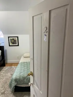 a bedroom with a bed and a white door at Cjay home 3 in Jersey City