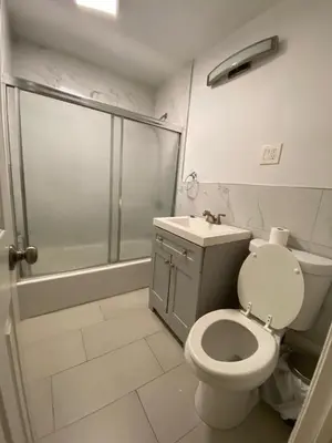 a bathroom with a shower and a toilet and a sink at Cjay home 3 in Jersey City