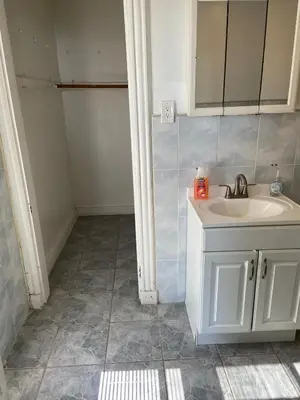 a bathroom with a sink and a mirror at Cjay home 3 in Jersey City