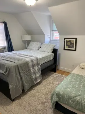 a bedroom with two beds and a window at Cjay home 3 in Jersey City