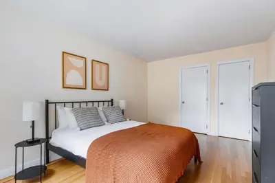 a bedroom with a bed and a tv at Blueground Murray Hill fitness center nr MetLife NYC-1929 in New York
