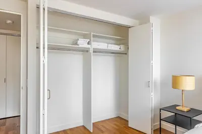 a bedroom with white walls and a closet at Blueground Tribeca pool nr City Hall NYC-1930 in New York