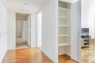 a room with white walls and a sliding glass door at Blueground Tribeca pool nr City Hall NYC-1930 in New York