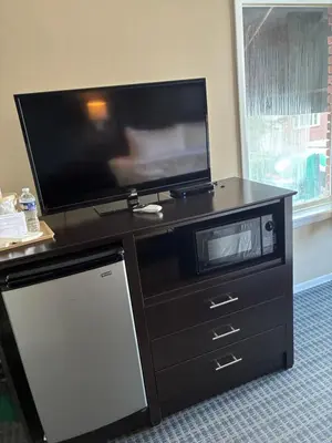 a flat screen tv sitting on top of a dresser at Mainstay Inn in Phoenixville