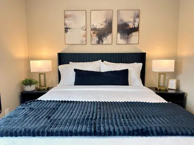 a bedroom with a large bed with two lamps at Mainstay Inn in Phoenixville