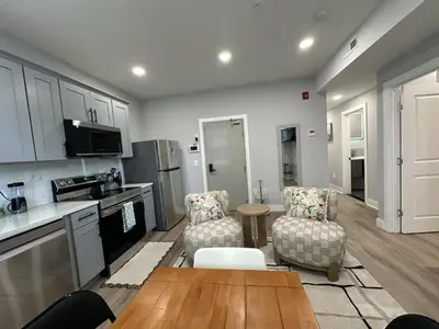 a kitchen and living room with a table and chairs at New Spacious 2 bedroom in Central Philly in Philadelphia