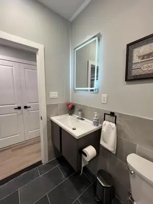 a bathroom with a sink and a toilet and a mirror at New Spacious 2 bedroom in Central Philly in Philadelphia
