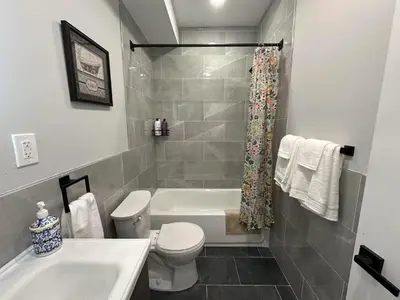 a bathroom with a tub and a toilet and a sink at New Spacious 2 bedroom in Central Philly in Philadelphia