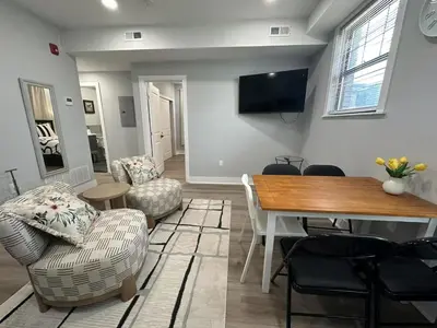 a living room with a dining room table and chairs at New Spacious 2 bedroom in Central Philly in Philadelphia