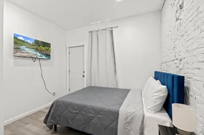 a bedroom with a bed and a white wall at The Soft Loft in Philadelphia