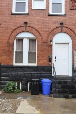 a building with two arched windows and a white door at The Soft Loft in Philadelphia