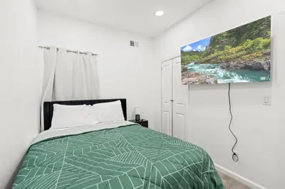 a bedroom with a bed and a tv on the wall at The Soft Loft in Philadelphia