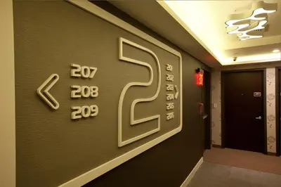 a room with a wall with numbers on it at NobleDEN Hotel in New York