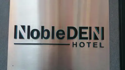 a sign for a nordleden hotel at NobleDEN Hotel in New York