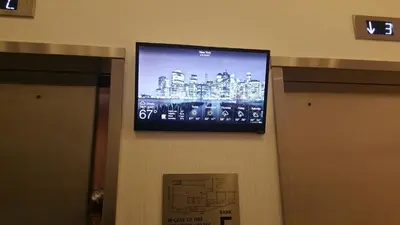 a flat screen tv hanging on a wall at NobleDEN Hotel in New York