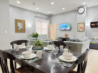 a dining room with a table and chairs and a couch at Huge apartment near NYC, Parking in North Bergen