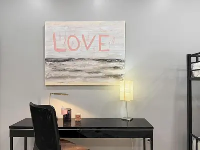 a black desk with a painting with the words love at Huge apartment near NYC, Parking in North Bergen