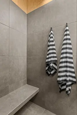 two towels hanging on the wall of a shower at Sunlit Airstream in Trees with Expansive Deck Nature Views in De Lancey