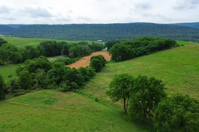 an aerial view of a field with a dirt road at Spectacular Buckleberry View EV Recharge Hot Tub Fireplace Jacuzzi in Spring Mills