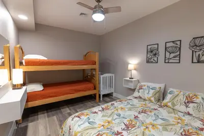 a bedroom with two bunk beds and a couch at Spectacular Buckleberry View EV Recharge Hot Tub Fireplace Jacuzzi in Spring Mills